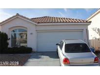 One-story home with attached garage and landscaping at 133 Mclaren St, Henderson, NV 89074
