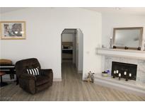 Living room with fireplace, hardwood floors and access to bedroom at 6836 Elm Creek Dr # 203, Las Vegas, NV 89108