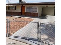 Ranch style home with carport and chain link fence at 3013 Piedmont Ave, Las Vegas, NV 89102