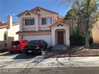 Two-story house with attached garage and landscaping at 8769 Country View Ave, Las Vegas, NV 89129