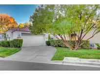 Single-story home with attached garage and well-manicured lawn at 6934 Emerald Springs Ln, Las Vegas, NV 89113