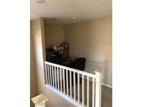 Upstairs loft area, perfect for an office or study, features built-in shelving and a desk at 5661 African Lilly Ct, Las Vegas, NV 89130