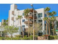 Modern building exterior with palm trees and landscaping at 11441 Allerton Park Dr # 214, Las Vegas, NV 89135