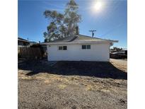 Simple white house exterior with a yard at 11 Avenue I, McGill, NV 89318