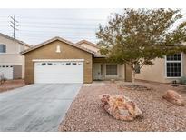 Charming single-story home with a two-car garage and landscaped yard at 6214 Osaka Pearl St, North Las Vegas, NV 89031