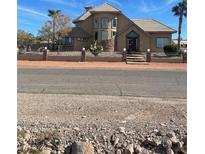 Two-story house with a tile roof, multiple windows, and a large front yard at 343 Fife St, Henderson, NV 89015