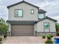 Two-story house with gray exterior and brown garage door at 7112 Sayonara Vista St, North Las Vegas, NV 89084