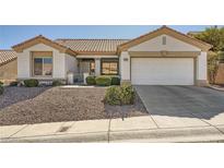 Single-story home with a two-car garage and landscaped yard at 10809 Clarion Ln, Las Vegas, NV 89134