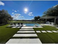 Stunning pool with artificial turf and outdoor kitchen at 5 Clear Crossing Trl, Henderson, NV 89052