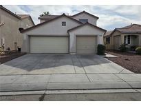 Two-story house with attached two-car garage at 1805 Running Fawn Ct, North Las Vegas, NV 89031