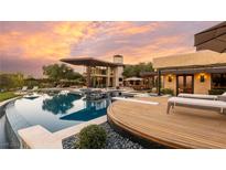 Luxury pool and patio area with a large deck and stunning sunset views at 5 Promontory Ridge Dr, Las Vegas, NV 89135