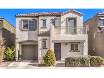 Two-story house with balcony, attached garage, and well-manicured landscaping at 7322 Drumlin St, Las Vegas, NV 89139