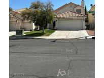 Two-story house with attached garage and landscaped yard at 9417 Amber Valley Ln, Las Vegas, NV 89134