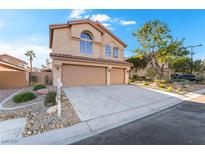 Two story house with two car garage and landscaped yard at 7813 Paper Flower Ct, Las Vegas, NV 89128