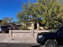 Ranch style home with mature trees and block wall in front at 6120 Kimberly Cir, Las Vegas, NV 89107