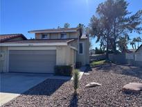 Two-story house with a two-car garage and rock landscaping at 8817 Borla Dr, Las Vegas, NV 89117