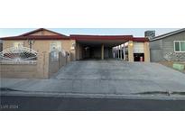 House exterior featuring a carport and a white fence at 5530 Plainview Ave, Las Vegas, NV 89122