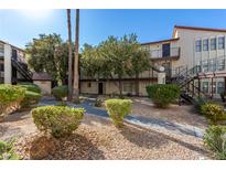 Condo building with walkway, landscaping, and stairs at 2080 Karen Ave # 94, Las Vegas, NV 89169