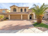 Two-story house with three-car garage and landscaped front yard at 10052 Baystone St, Las Vegas, NV 89141