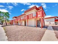 Red exterior apartment building with stairs and walkway at 5388 Swenson St # 26, Las Vegas, NV 89119