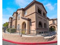 Tan two-story building with arched entryways and metal railings at 7660 W Eldorado Ln # 228, Las Vegas, NV 89113