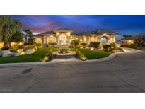 Elegant home exterior at night with landscape lighting at 1700 Brock Ct, Las Vegas, NV 89117