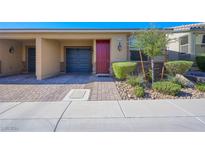 Tan house with red door, attached garage, and landscaped front yard at 2675 Chinaberry Hill St, Laughlin, NV 89029