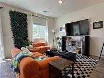 Modern living room featuring comfortable seating and a large TV at 4273 Venus Falls Ave, North Las Vegas, NV 89084