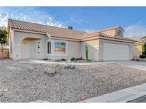 Single-story house with desert landscaping and a two-car garage at 7633 Falconwing Ave, Las Vegas, NV 89131