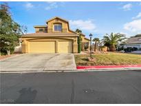 Two-story home with double-car garage and landscaping at 7942 Quail Mountain Ln, Las Vegas, NV 89131