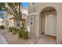 Townhouse exterior with a decorative door and landscaping at 8556 Tellima Ct, Las Vegas, NV 89149
