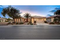 Single-story home with a two-car garage and desert landscaping at 4729 Regalo Bello St, Las Vegas, NV 89135