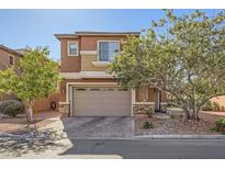 Two-story house with tan exterior, stone accents, and a two-car garage at 759 Crimson Peak Pl, Henderson, NV 89011