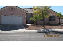 One-story house with a two-car garage and desert landscaping at 8637 Stone Harbor Ave, Las Vegas, NV 89145