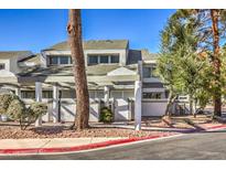 Two-story condo with a covered entryway and mature trees at 5502 Orchard Ln # 0, Las Vegas, NV 89110