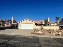 House exterior with a garage and landscaping at 3218 Ocotillo Dr, Laughlin, NV 89029
