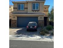 Two-story home with dark gray garage door at 2668 Duneville St, Las Vegas, NV 89146