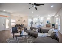 Open living room with kitchen and dining area at 10624 Mission Lakes Ave, Las Vegas, NV 89134