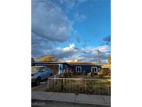 Ranch style home with blue exterior, fenced yard, and driveway at 2108 Lenwood Ave, North Las Vegas, NV 89030