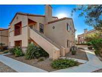 Tan two-story building with walkway and landscaping at 9070 Spring Mountain Rd # 216, Las Vegas, NV 89117