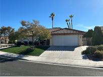 Single-story home with a white garage door and landscaped yard at 2600 Gray Fox Rd, Henderson, NV 89074