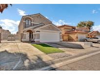 Two-story house with a white garage door and landscaping at 5849 Killala Ct, Las Vegas, NV 89110