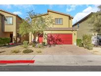 Two-story house with red garage door and landscaped front yard at 1054 Twincrest Ave, North Las Vegas, NV 89032