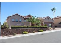 One-story house with a landscaped yard and a stone wall at 2900 Foxtail Creek Ave, Henderson, NV 89052