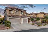 Two-story house with a three-car garage and landscaped front yard at 1118 Riddle Glen St, Henderson, NV 89012