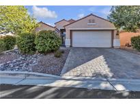 Single-story house with a two-car garage and landscaped front yard at 11605 Cabo Del Sol Ct, Las Vegas, NV 89138