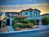 Two-story house with gray exterior, landscaping, and a two-car garage at 10029 Scenic Walk Ave, Las Vegas, NV 89149