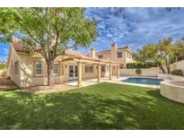 Luxury home with a spacious backyard, sparkling pool, and artificial turf at 5413 Aegean Way, Las Vegas, NV 89149