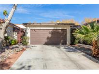 Front view of a home with a brown garage door and a paved driveway at 2528 Laconia Ave, Las Vegas, NV 89121