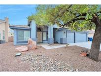 Single-story home with two-car garage and landscaped front yard at 4514 Patriot Cannon St, North Las Vegas, NV 89031